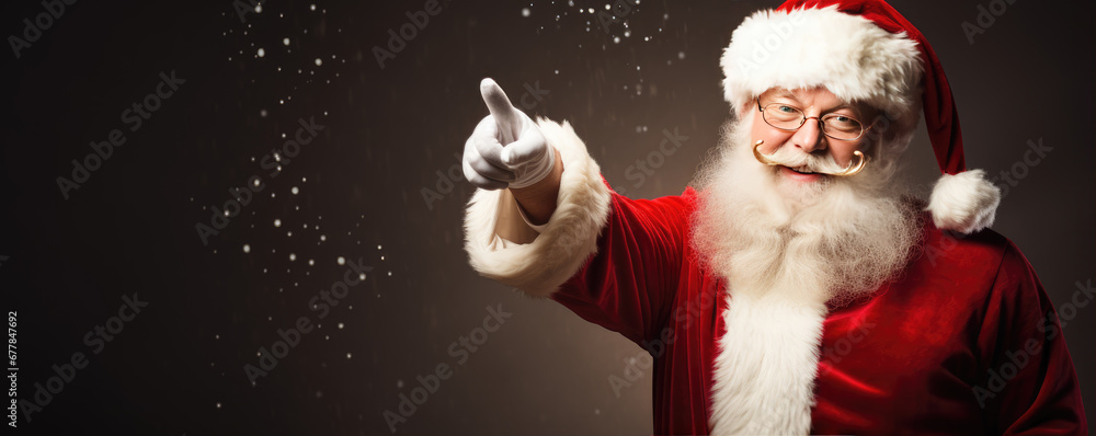 Portrait of the Santa Claus pointing his finger and smile for the camera . Portrait of the Santa Claus pointing his finger and smile for the camera .