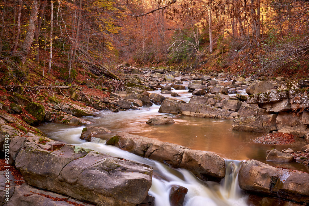 autumn landscape with mountain river and silky waterfall