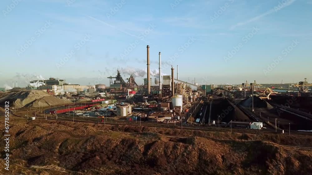 Steel production factory with smoke out of chimneys in the Netherlands