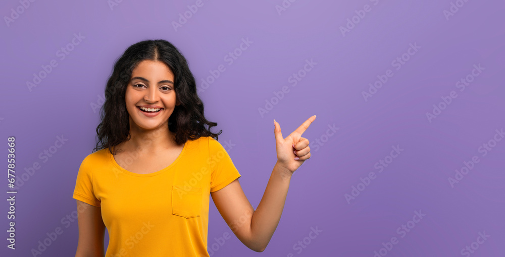 Happy young indian lady pointing at free space Happy young indian lady pointing at free space