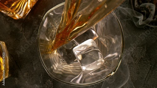 Pouing Whisky into Glass, camera move in super slow motion. Shot with high speed cinema camera, 1000fps. photo