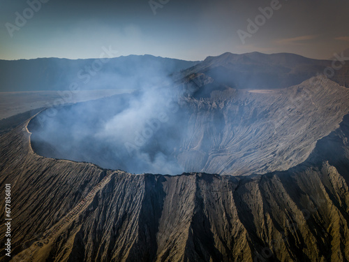 Active volcano crater, Bromo, East Java, Indonesia. Aerial panorama View of Smoke Gas Steam coming from crater at daytime