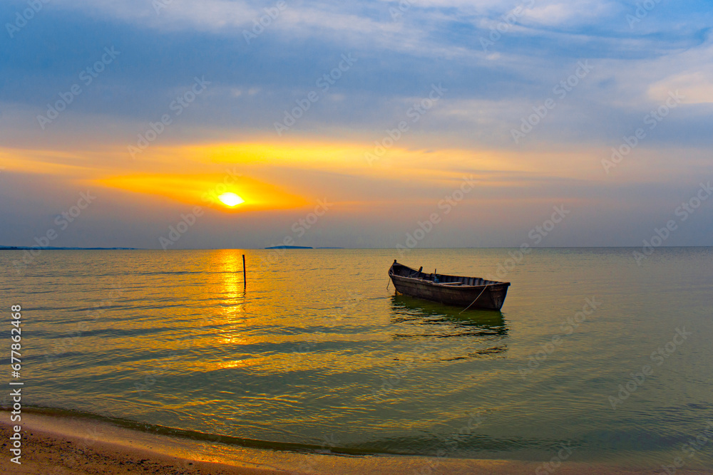 boat at sunrise on the lake