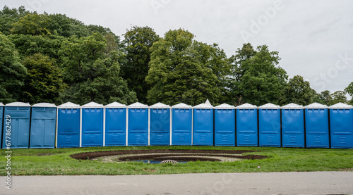 Long row of blue portable toilets.