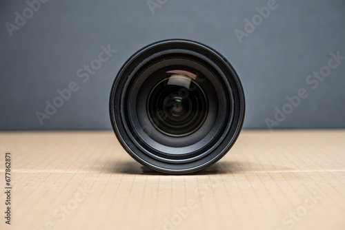Large aperture photographic lens on a brown table.