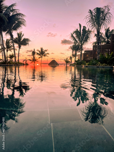 Sunrise over the Gulf of Mexico reflected into the infinity pool at the resort photo