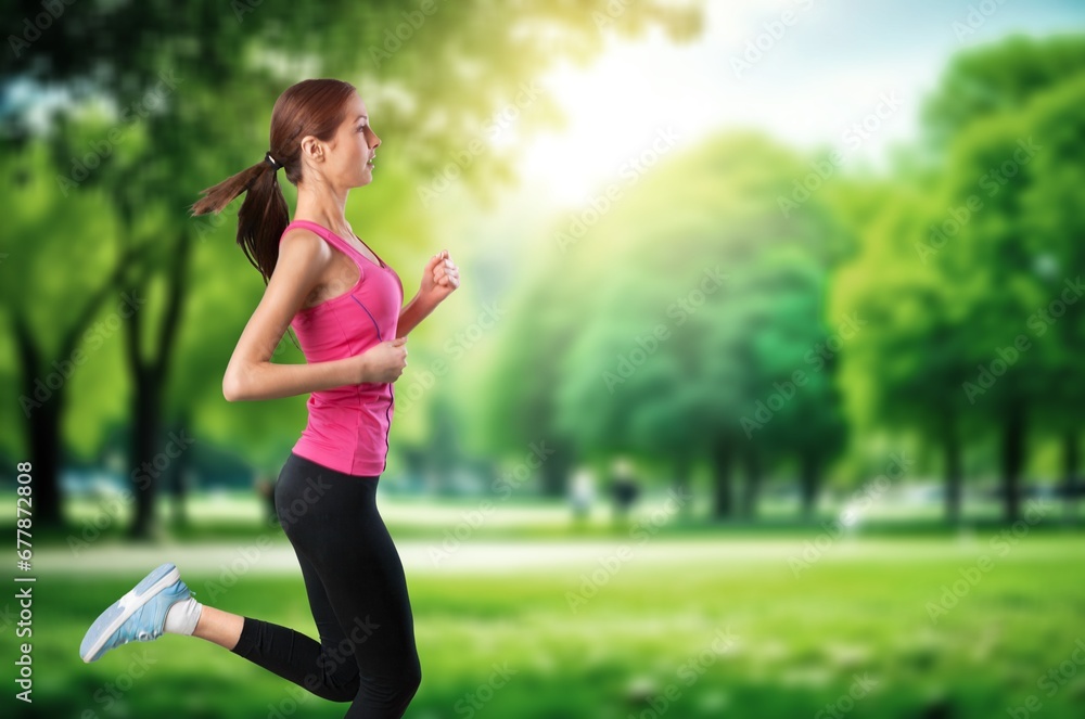 Happy millennial woman in sportswear enjoys running
