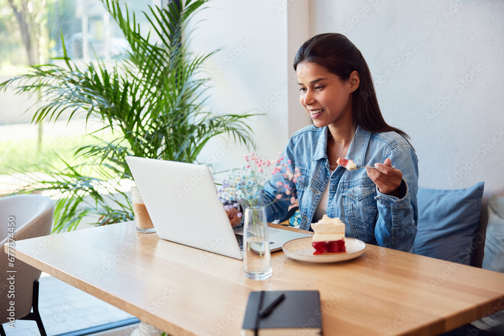 Woman having coffee break with laptop at cafe Woman having coffee break with laptop at cafe