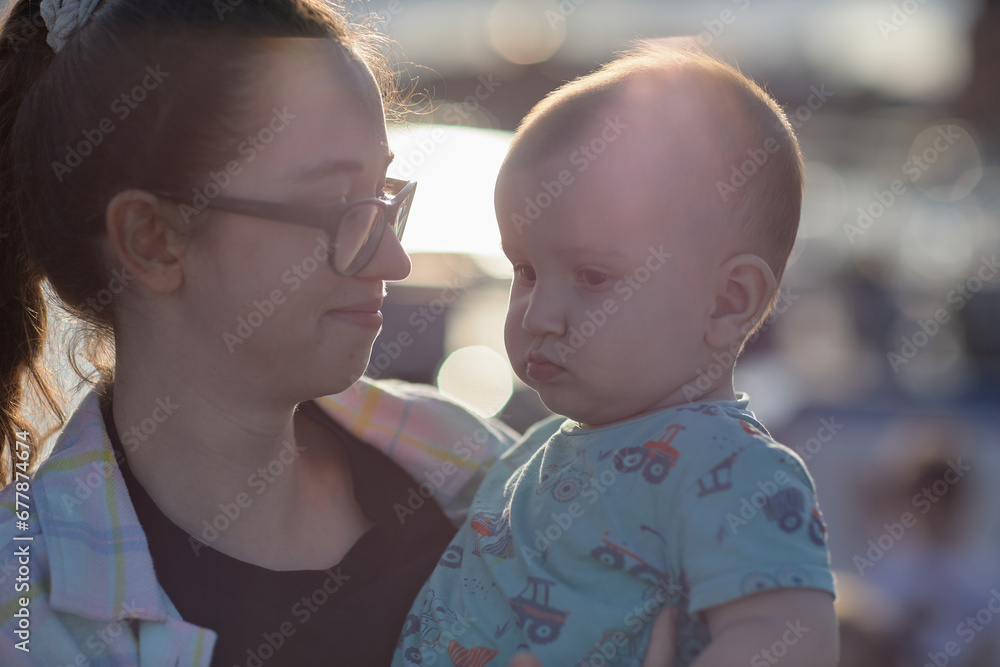 happy child with mother in glasses on sunset background happy child with mother in glasses on sunset background