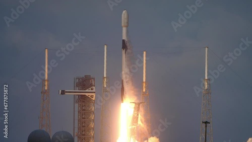 Spectacular shot of a Space Rocket blasting off from launch pad as it flies to space on its mission to place communication satellites in earth orbit. 4K. Slow-motion. Includes sound and audio.