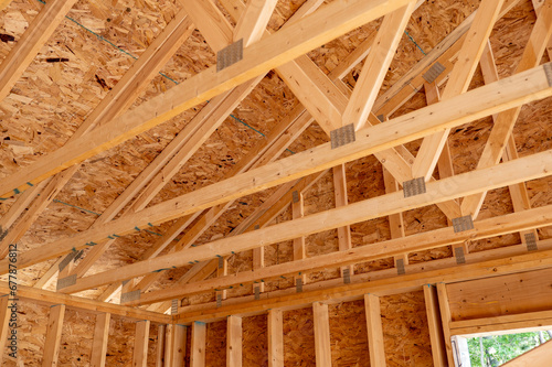Wood rafters are seen over the corner of the garage in a new home construction.