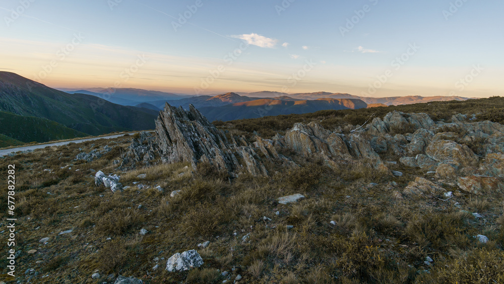View from Serra da Arada over mountain landscape at evening sunset with sharp rocks in foreground, Sao Pedro do Sul, Portugal - obrazy, fototapety, plakaty 
