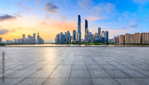 empty square floor and guangzhou skyline with modern buildings at sunrise guangdong province china panoramic view © Art_me2541