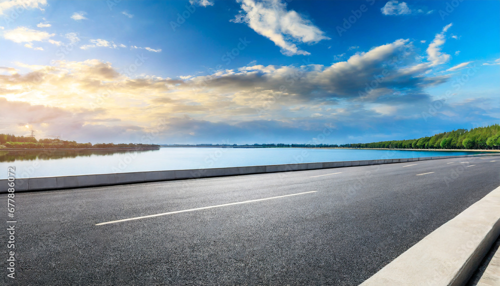 asphalt road highway and lake with sky clouds under the blue sky asphalt road highway and lake with sky clouds under the blue sky
