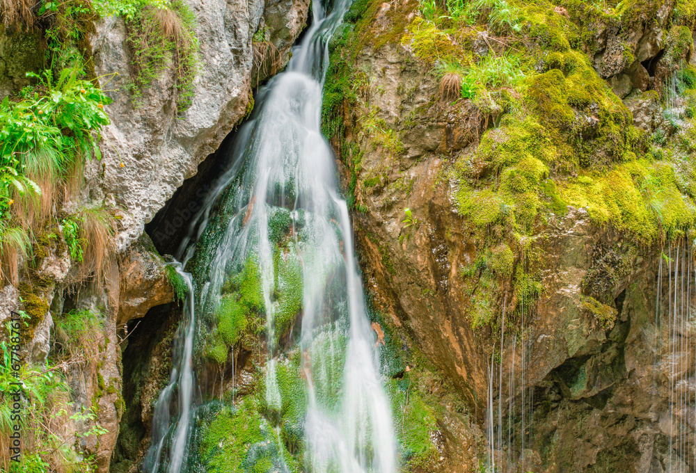 waterfall with flowing water in the mountain