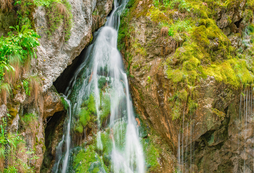 Obraz na płótnie waterfall with flowing water in the mountain w salonie