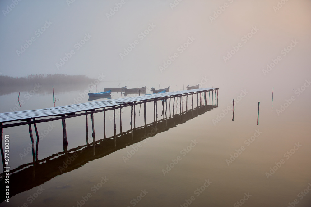 fishing boats at sunrise on the lake