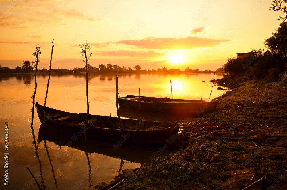 sunrise with boats on the lake