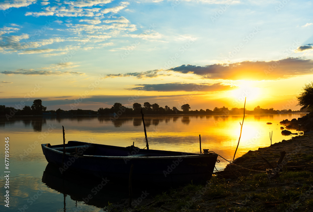 sunrise with boats on the lake