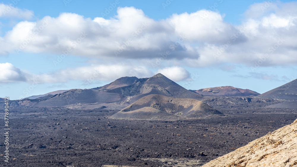 The lunar landascape of lava with the vulcanos in Lanzarote, canaries, view of the Timanfaya national park The lunar landascape of lava with the vulcanos in Lanzarote, canaries, view of the Timanfaya national park