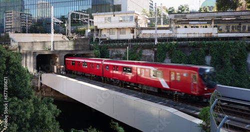 Red train coming out of the tunnel. Scenery near Ochanomizu Station in Tokyo.