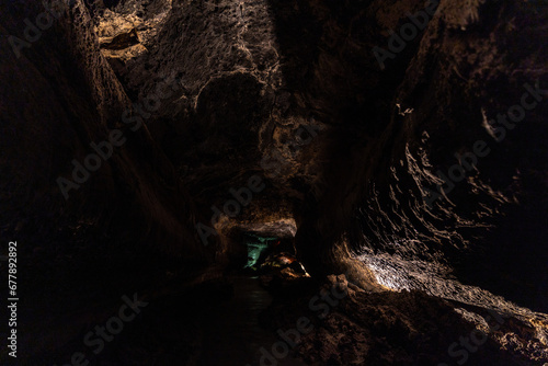 cueva de los verdes, colorful vulcanic rocks in cave with lake still calm reflecting, lava tube in Lanzarote, Canary Islands