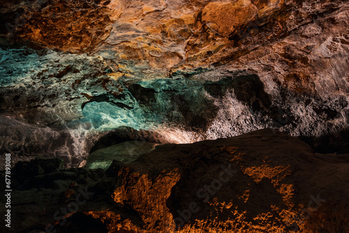 cueva de los verdes, colorful vulcanic rocks in cave with lake still calm reflecting, lava tube in Lanzarote, Canary Islands