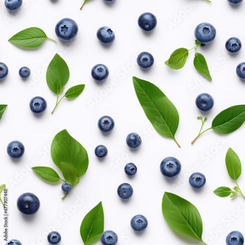 pattern of ripe blueberries and green fresh leaves on a white background