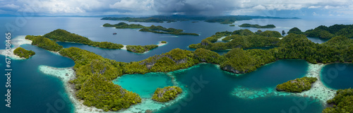 Rain clouds slowly approach the incredible islands of Pef in Raja Ampat, Indonesia. These stunning islands are fringed by mangrove trees and surrounded by beautiful coral reefs.