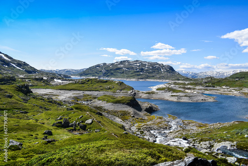 Absolutely stunning panoramic view of the mountains  peaks  fjords and lakes of Norway during summer. Have the adventure of a lifetime in Scandinavia. 