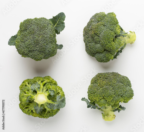 Flat lay with fresh broccoli on white background