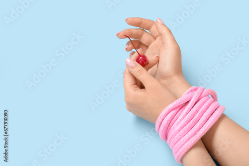 Female hands with pink rope...
