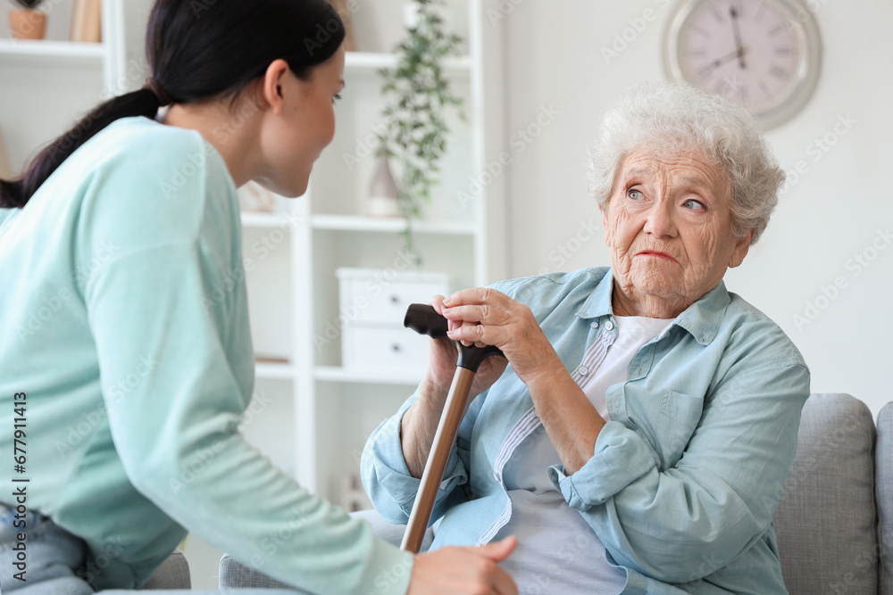 Upset senior woman with her displeased daughter at home Upset senior woman with her displeased daughter at home