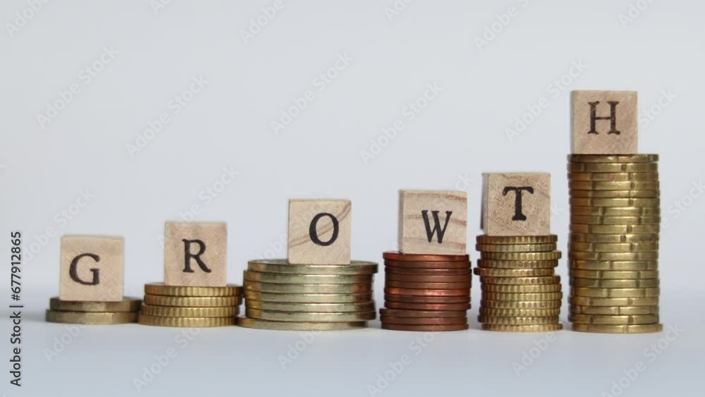 Stop motion video of  coins stacking up and block letters forming the word GROWTH