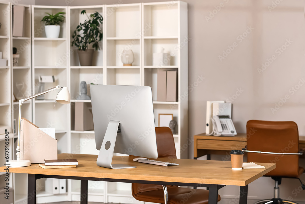 Modern workplace with computer monitor and coffee cup in office Modern workplace with computer monitor and coffee cup in office