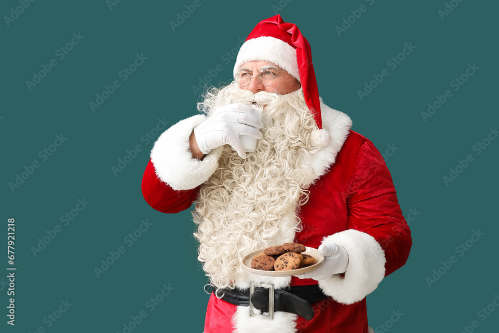 Santa Claus drinking milk with cookies on green background Santa Claus drinking milk with cookies on green background