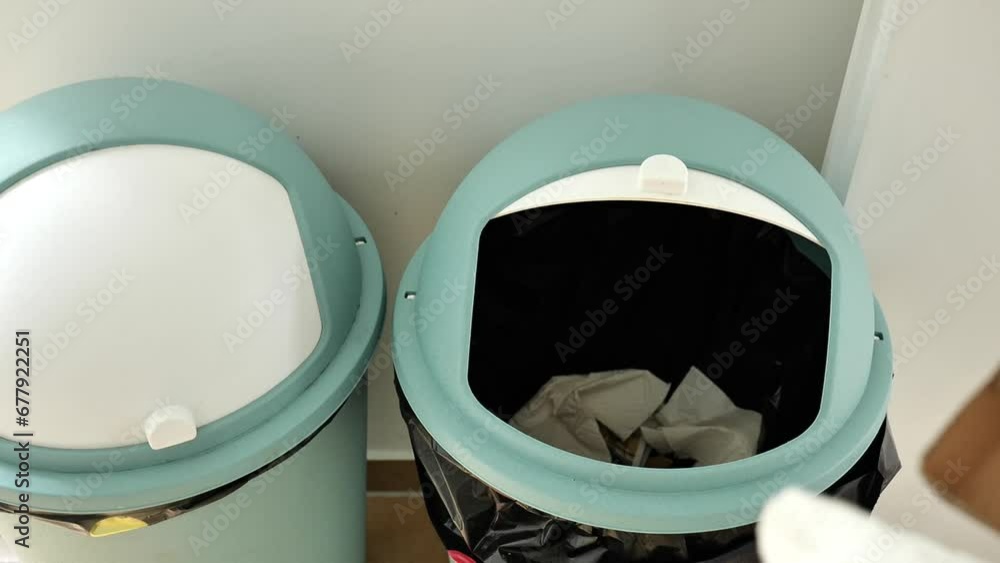 Sorting paper for recycling. Zero waste .womans hand throws paper trash into a gray used trash can. 4k footage Sorting paper for recycling. Zero waste .womans hand throws paper trash into a gray used trash can. 4k footage