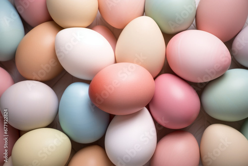 Easter eggs painted in pastel colors to celebrate Easter. Painted eggs on white sunny table, top down view.