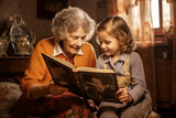 Grandmother and granddaughter watching old photo album at home. Senior woman showing to child black and white retro photos. Retired person and kid happy together.