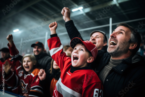 Excited parents and kids celebrating the victory of their team. Sports fans chanting and cheering for their ice hockey team. Family with children watching hockey match.