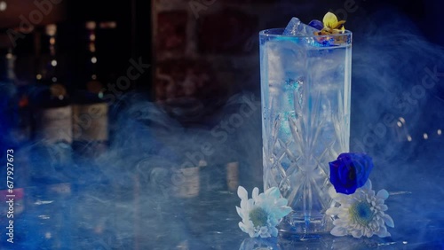 Dry ice blowing near an iced drink in a bar photo