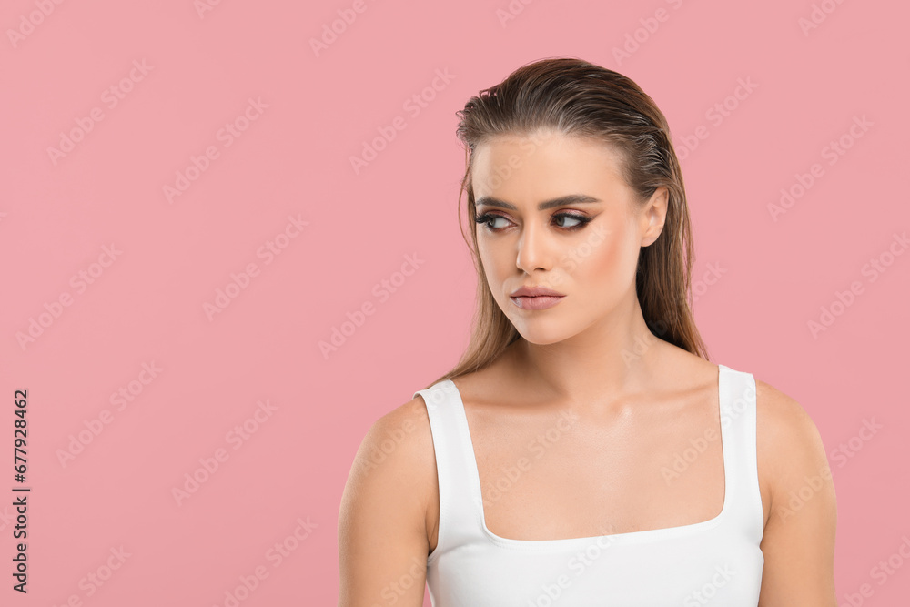 Beautiful woman with makeup on pink background, space for text Beautiful woman with makeup on pink background, space for text