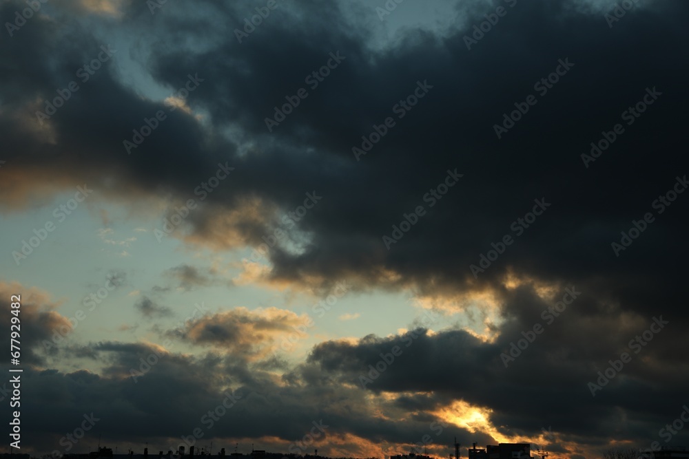 Fototapeta premium Beautiful sky with dark clouds over city in evening