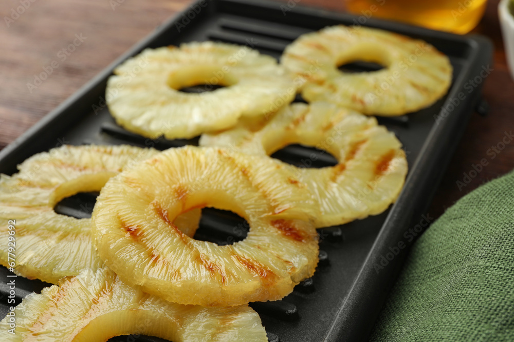 Tasty grilled pineapple slices on table, closeup Tasty grilled pineapple slices on table, closeup
