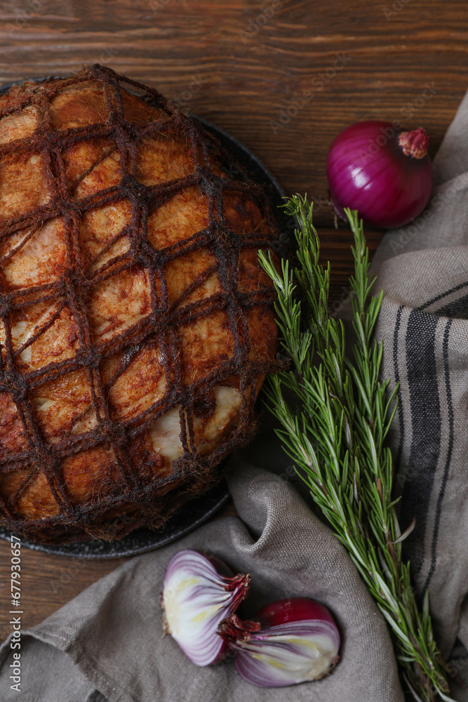 Delicious baked ham, onion and rosemary on wooden table, flat lay