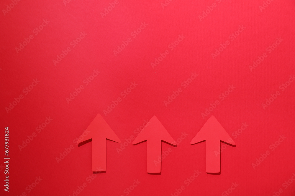 Paper arrows on red background, flat lay. Space for text Paper arrows on red background, flat lay. Space for text