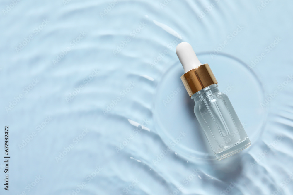 Bottle of cosmetic serum and water on light blue background, top view. Space for text Bottle of cosmetic serum and water on light blue background, top view. Space for text