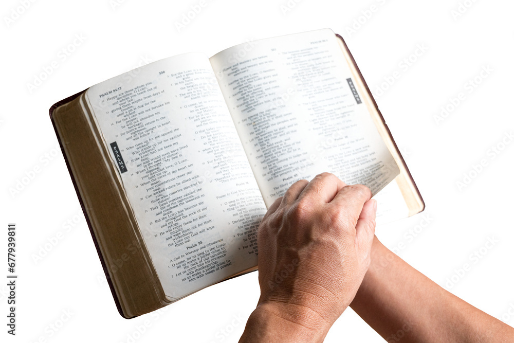 Fototapeta premium Man reading and turning the page of the Holy Bible. Close up shot. Isolated, transparent background.