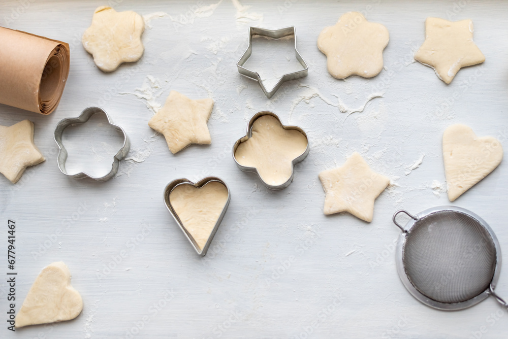 Top view of cooking a gingerbread cookie in the form of heart, star, cloud and flower. Christmas and New Year concept, festive preparations for winter hilodays. Top view of cooking a gingerbread cookie in the form of heart, star, cloud and flower. Christmas and New Year concept, festive preparations for winter hilodays.