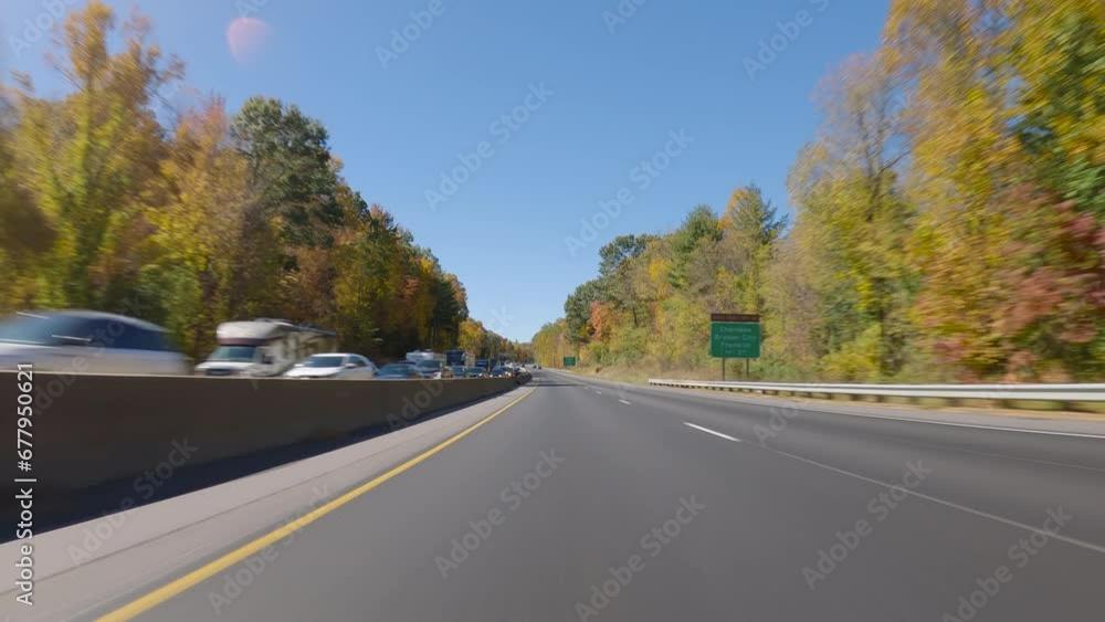 POV driving a car up on mountain highway, autumn scenery with colorful trees POV driving a car up on mountain highway, autumn scenery with colorful trees
